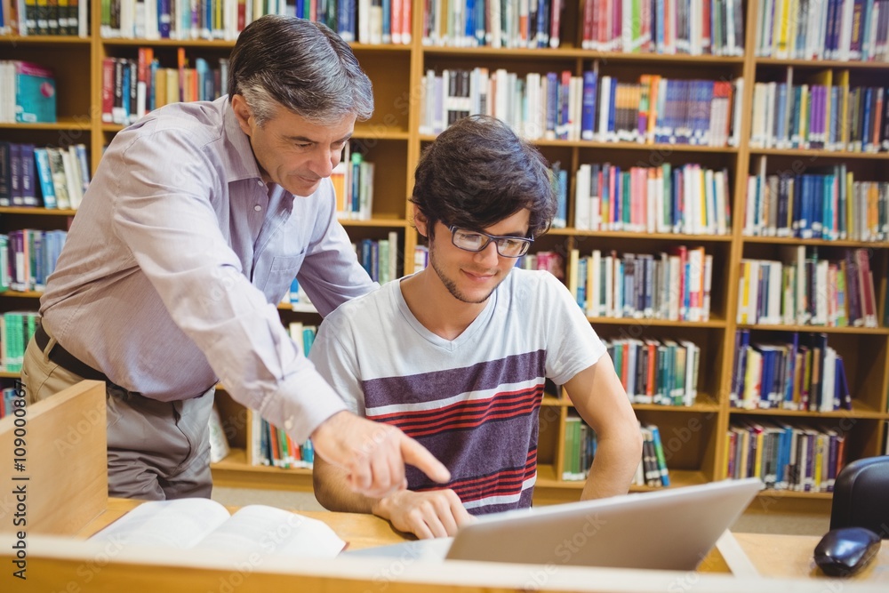 Professor assisting a student with laptop Professor assisting a student with laptop