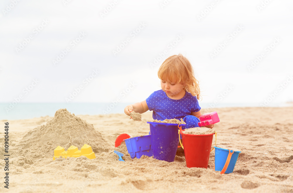little girl play with sand on beach little girl play with sand on beach