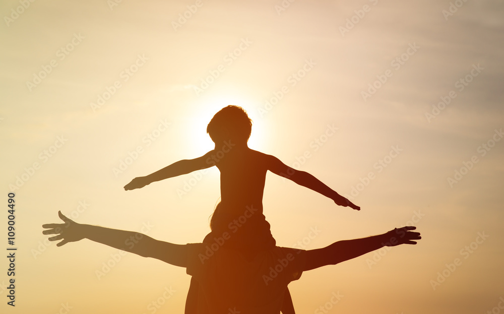 father and son having fun at sunset father and son having fun at sunset