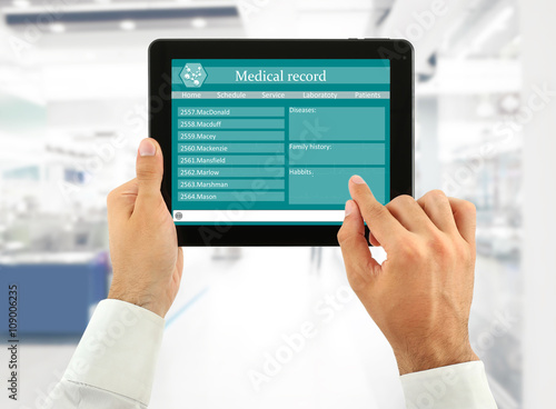 Medical tablet in doctor hands on light background