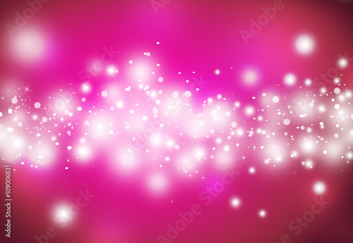 Pink glitter sparkles defocused rays lights bokeh abstract christmas background.