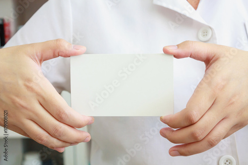 pharmacist holding blank paper in the pharmacy store