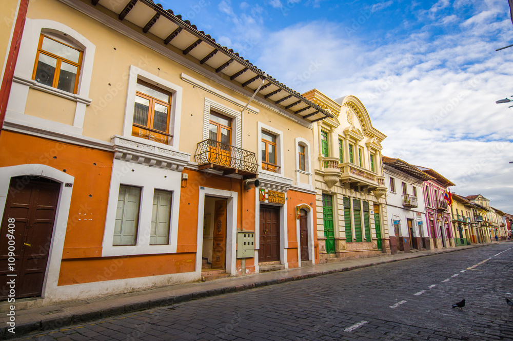 Cuenca, Ecuador - April 22, 2015: Bridgestone roads in city centre with charming and beautiful buildings architecture, small townhouses provides a very cozy atmosphere