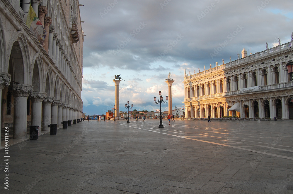 Naklejka premium the sun's rays light up the building on the historic square in Venice