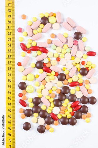 Cuadro en lienzo Colorful medical pills and centimeter on white background, health care, healthy