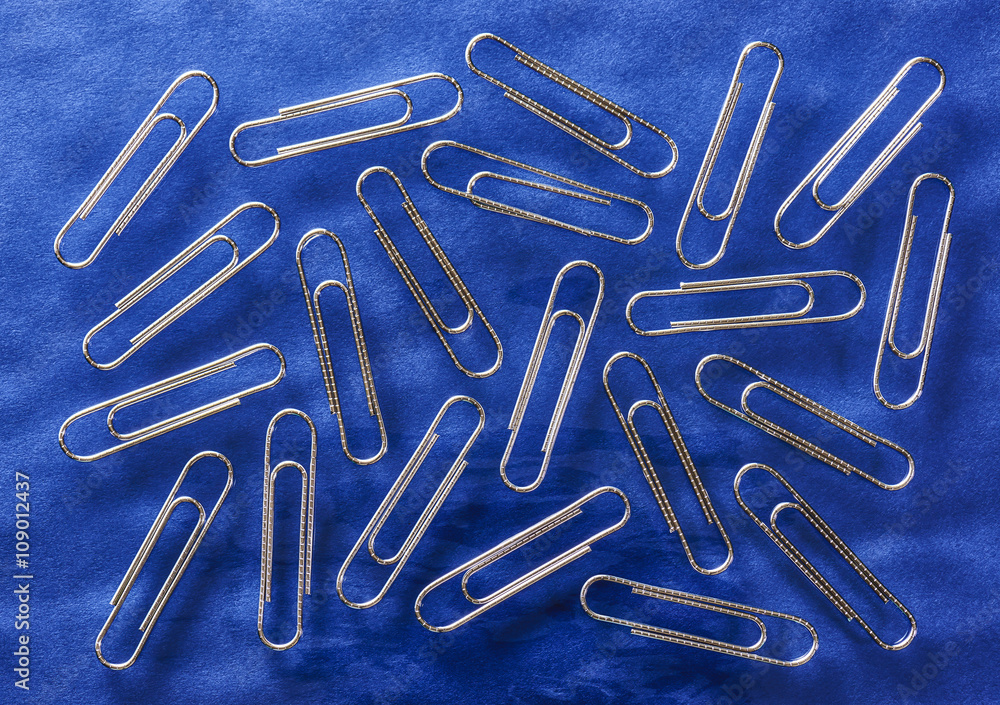 Paper clips. On blue background. Paper clips. On blue background.