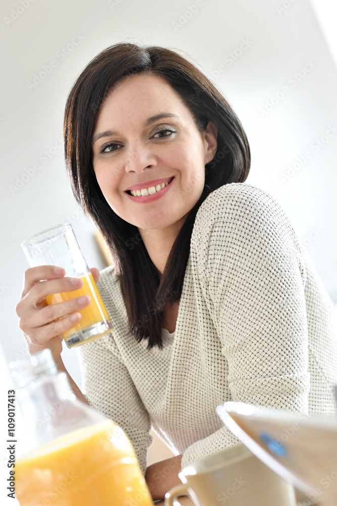 Portrait of mature woman drinking orange juice Portrait of mature woman drinking orange juice