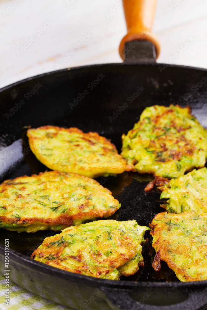 Zucchini Pancakes With  Sour Cream in Pan