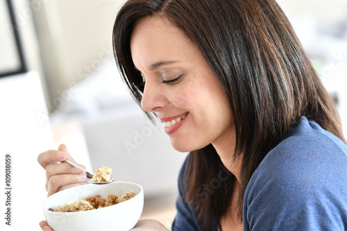 Portrait of mature woman eating cereals