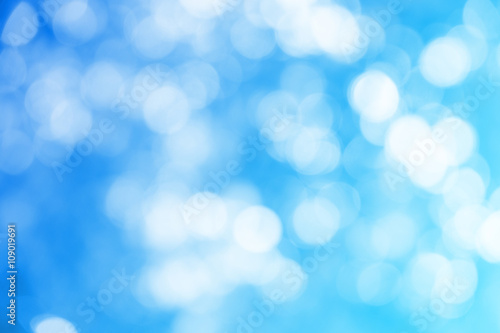 Blue ray bokeh glitter defocused lights abstract background.