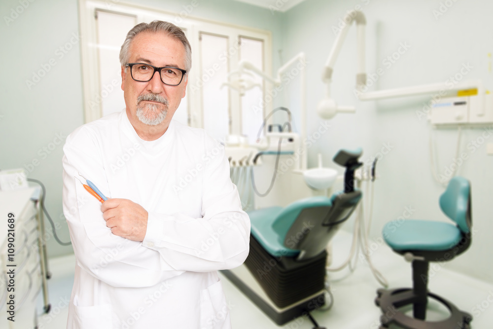 Senior dentist standing at her office Senior dentist standing at her office