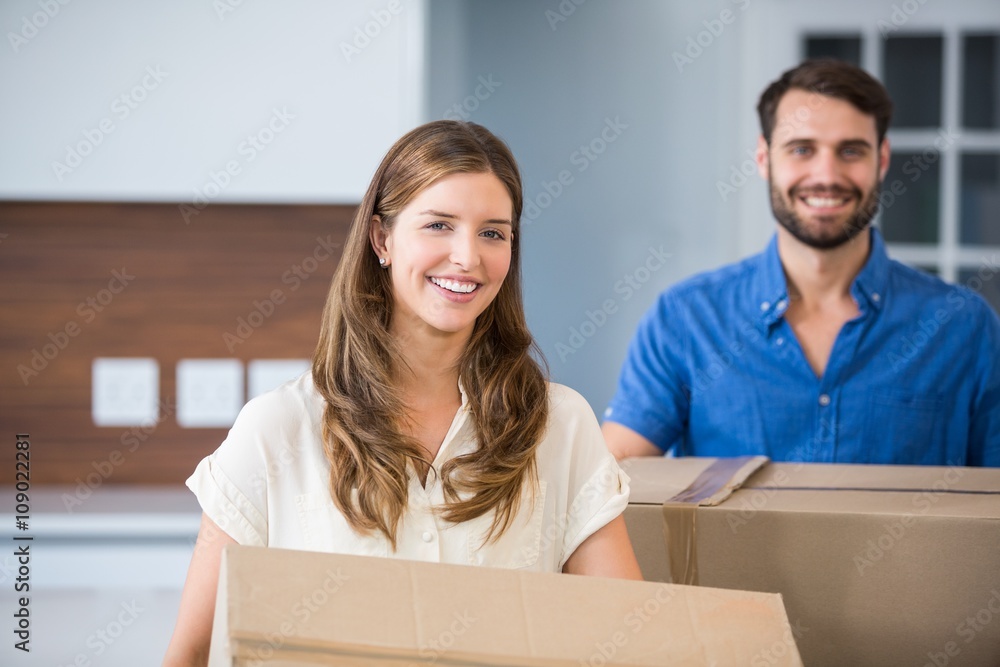 Portrait of couple holding boxes Portrait of couple holding boxes