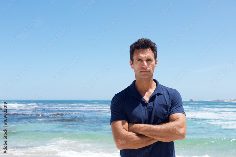 Handsome middle aged man with serious expression at the beach Handsome middle aged man with serious expression at the beach