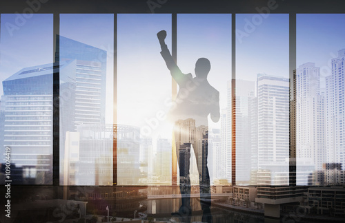 silhouette of business man over city background