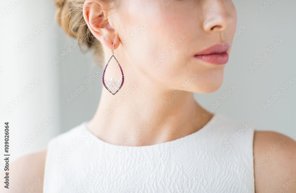 close up of beautiful woman face with earring close up of beautiful woman face with earring