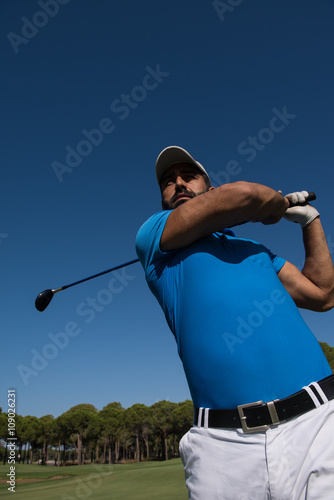 golf player hitting shot