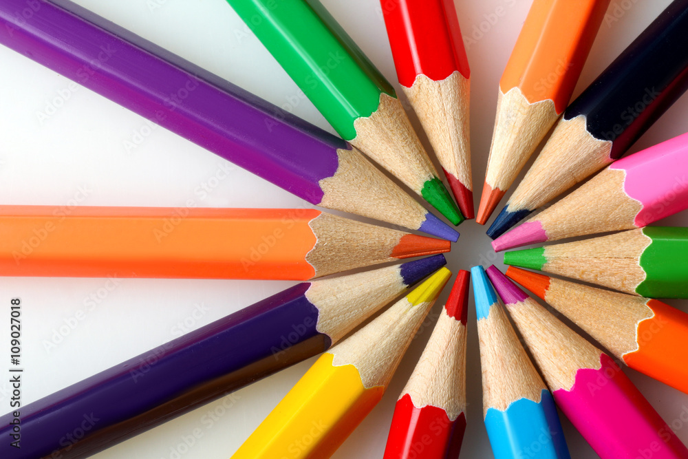 a lot of colored pencils lying on a white isolated background touching the tips to each other a lot of colored pencils lying on a white isolated background touching the tips to each other