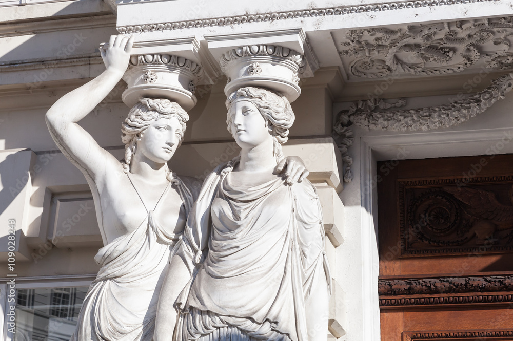 Fototapeta premium Statues of two young women in form of columns