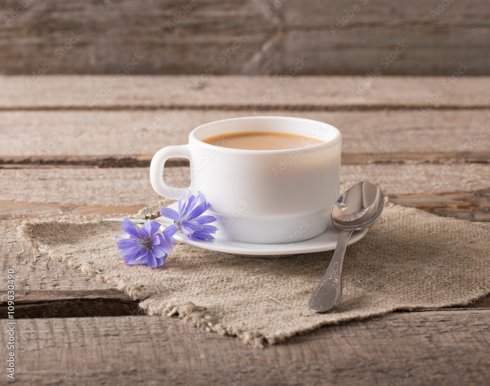 Cup of tea with chicory on wooden background Cup of tea with chicory on wooden background