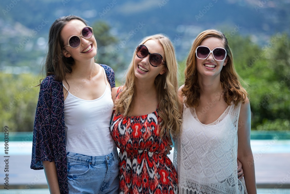 Portrait of beautiful women smiling near pool