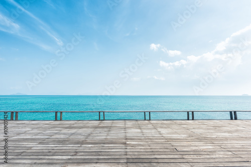 wooden floor with beautiful ocean and blue sky scenery
