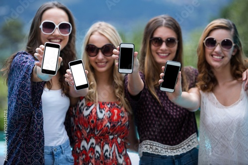 Beautiful women showing their mobile phones