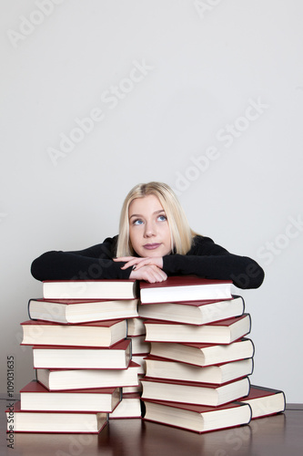 woman lying on books
