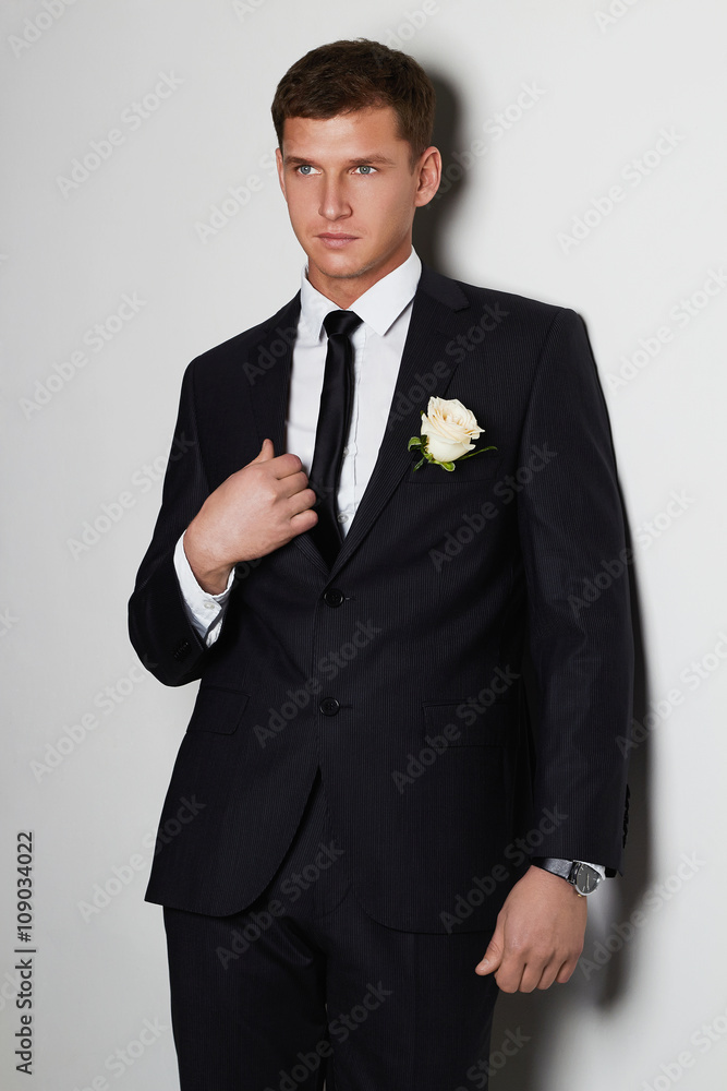 Handsome man with flower. young groom man in suit.elegant boy Handsome man with flower. young groom man in suit.elegant boy