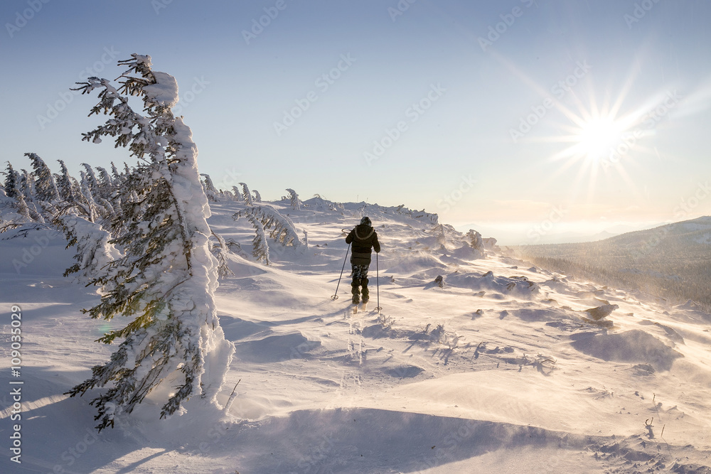 Hiker Travel in winter mountains at sunrise in Ural