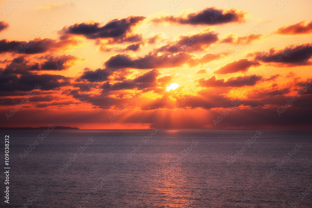 sunset over sea with sun rays