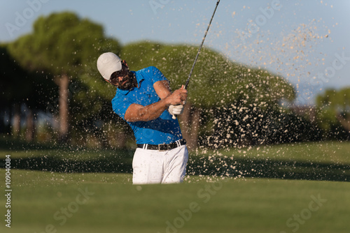 pro golfer hitting a sand bunker shot