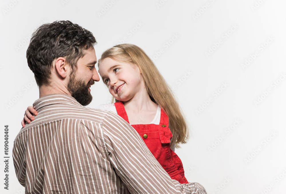 Girl hugging her father over a white background Girl hugging her father over a white background