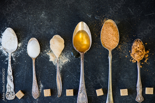 фотографія Different Kinds of Sugar in the Spoons