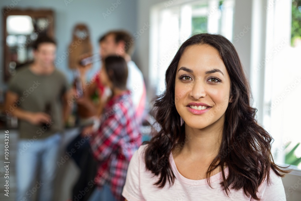 Portrait of happy woman with friends at home