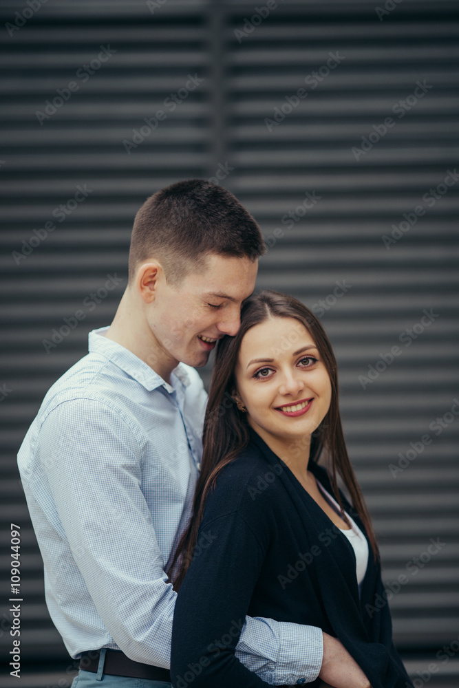 Lovely couple standing on the street and kissing Lovely couple standing on the street and kissing