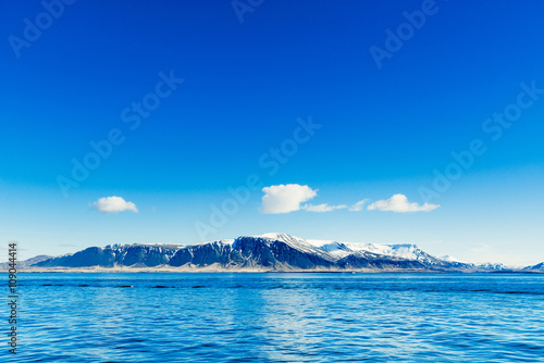 Blue ocean with distant mountains