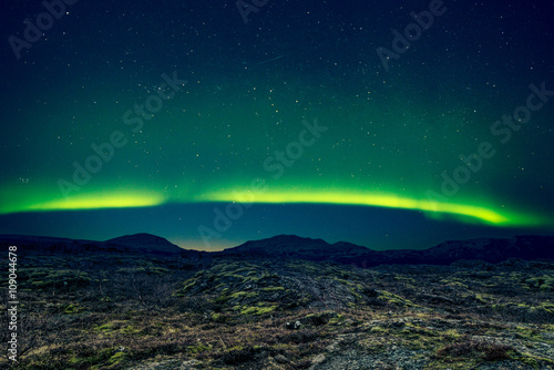 Northern lights over distant mountains © Polarpx