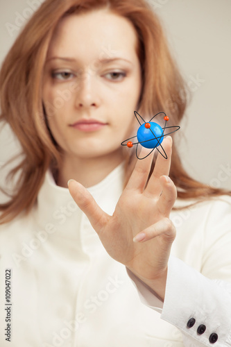 Woman scientist with atom model, research concept