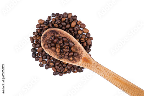 Spread coffee seeds and spoon on a white background