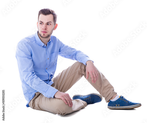 portrait of sad man thinking about something sitting isolated on