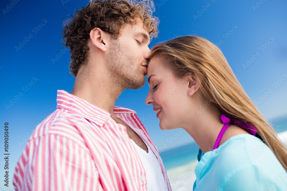Happy couple embracing on the beach Happy couple embracing on the beach