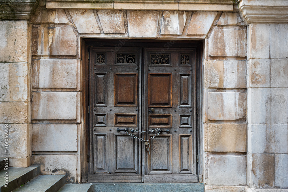 Chained up wooden doors with stone steps leading down to them Chained up wooden doors with stone steps leading down to them