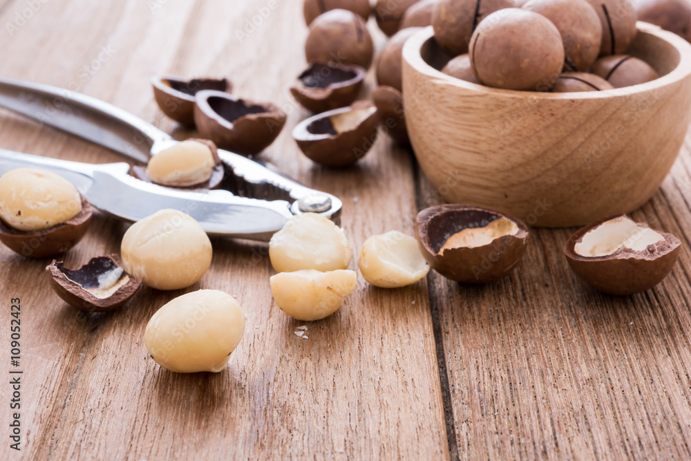 close up macadamia nut oil on the wooden plate, healthy concept close up macadamia nut oil on the wooden plate, healthy concept