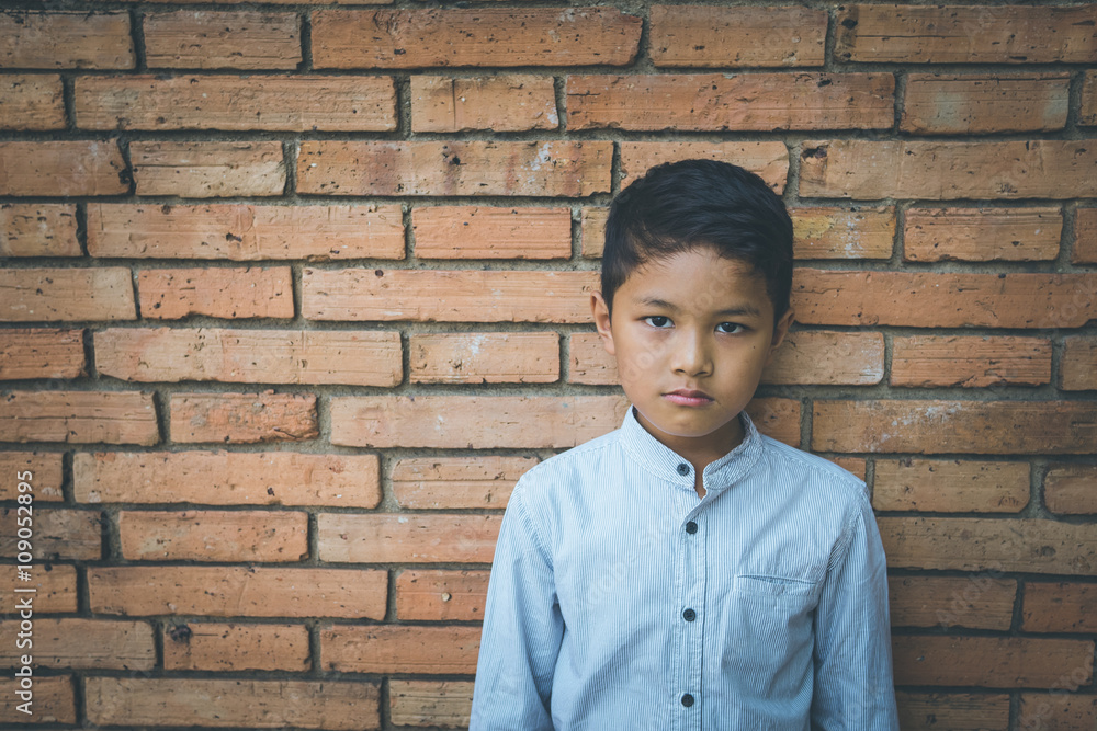 scared and alone, young Asian child who is at high risk of being bullied, trafficked and abused, selective focus scared and alone, young Asian child who is at high risk of being bullied, trafficked and abused, selective focus