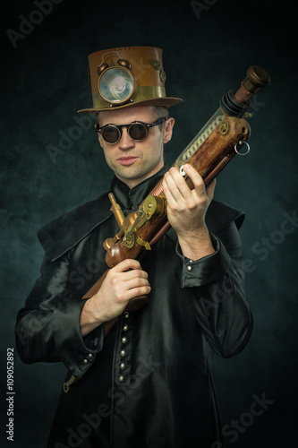 Steampunk man in a hat with gun