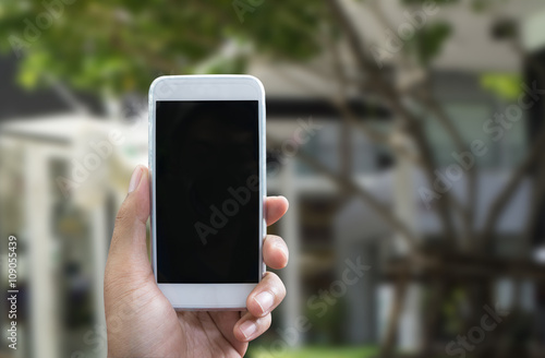 Man's hand shows mobile smartphone in vertical position