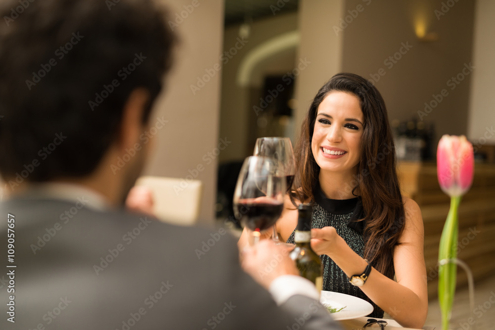 Couple toasting wineglasses in a restaurant Couple toasting wineglasses in a restaurant
