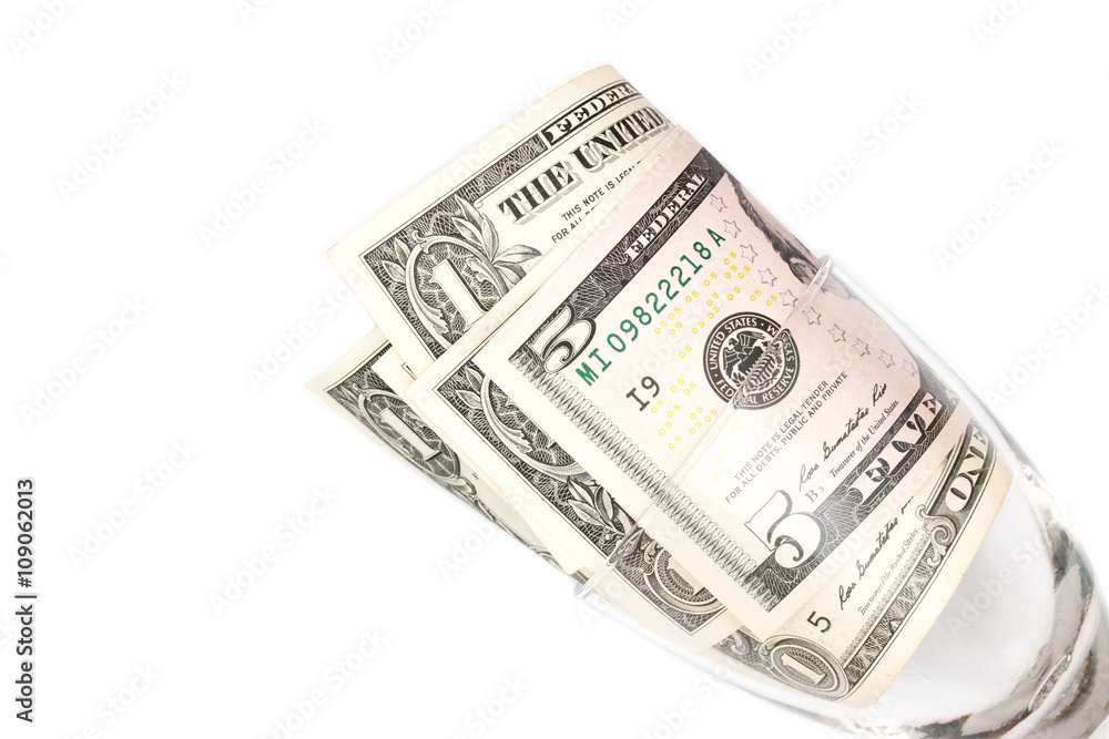 dollar bills in glass on white background dollar bills in glass on white background