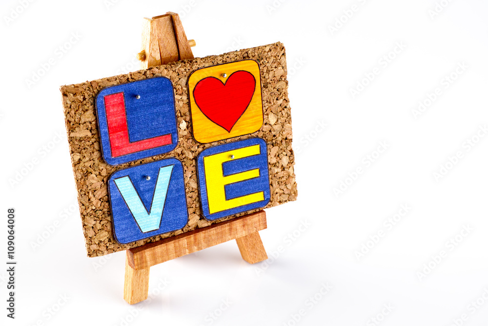 Wooden easel and corkboard with word Love. White background. Letter draw by me. Wooden easel and corkboard with word Love. White background. Letter draw by me.