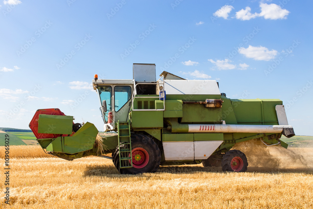 Combine harvester working on a wheat field. Combine harvester working on a wheat field.